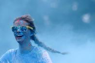 FILE PHOTO: A participant runs through coloured powdered in the five-kilometer 'Get Rainbowed' race in Prague, Czech Republic.