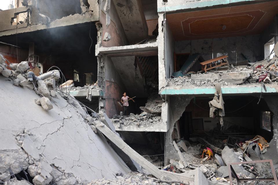 Palestinians children search through the rubble of their home on June 9, 2024, a day after an operation by the Israeli Special Forces that freed four hostages.