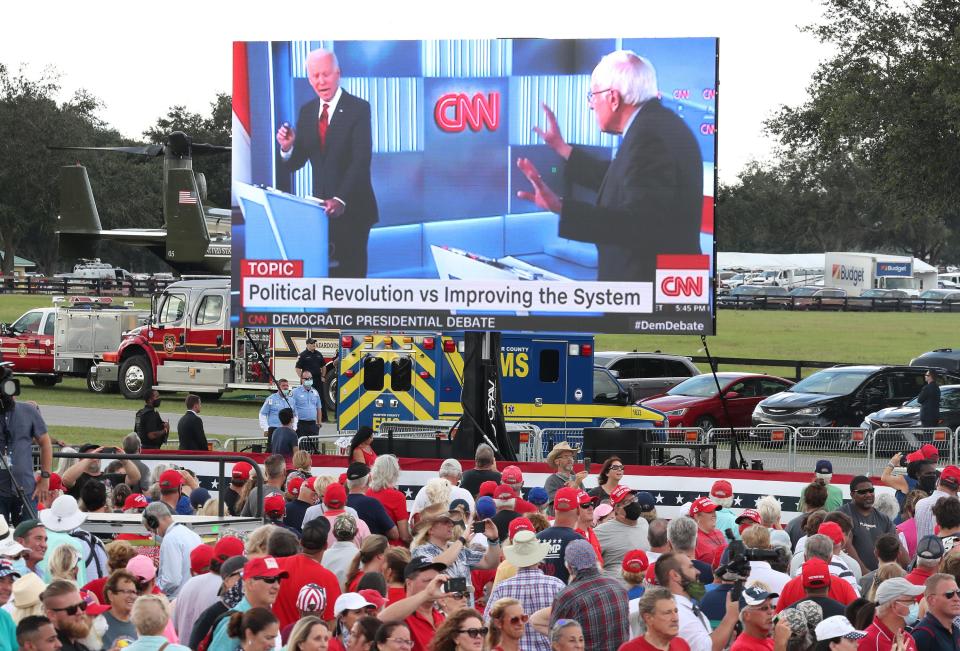 A video clip is shown as President Donald Trump speaks during a campaign event at The Villages Polo Club on Oct. 23, 2020 in The Villages, Florida. The clip shows Democratic presidential nominee Joe Biden and Sen. Bernie Sanders, I-Vt., arguing about Social Security during a Democratic presidential debate.