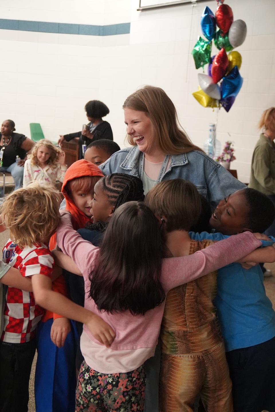 Maggie Allen hugs her first graders at Hall Fletcher Elementary.