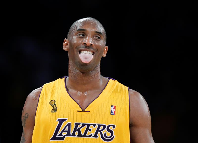 FILE PHOTO: Los Angeles Lakers Kobe Bryant celebrates a shot by Steve Blake against the Houston Rockets during a game in Los Angeles