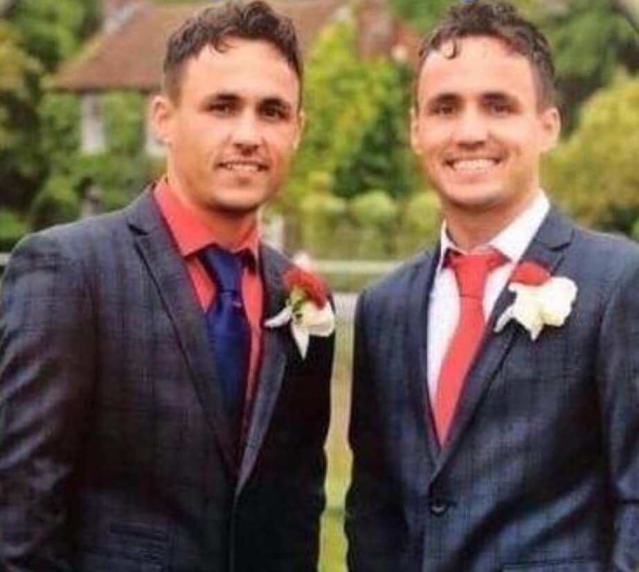 Bill and Joe Smith smiling wearing suits and corsages