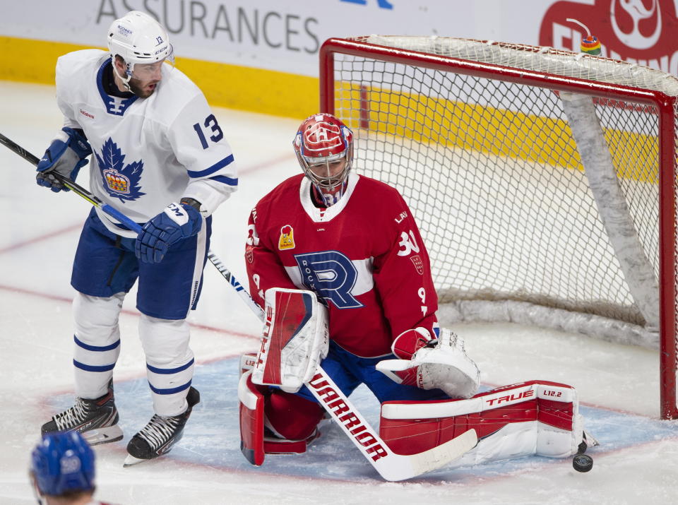 Laval Rocket goaltender Carey Price, right, makes a save as Toronto Marlies' Stefan Noesen looks for the rebound during first-period American Hockey League action in Montreal, Monday, May 17, 2021. Price and Brendan Gallagher are on a one-game conditioning loan to the Rocket before their playoff series against the Toronto Maple Leafs. (Ryan Remiorz/The Canadian Press via AP)