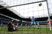 MANCHESTER, ENGLAND - MAY 13: Carlos Tevez (R) of Manchester City celebrates as the shot from teammate Pablo Zabaleta (C) beats goalkeeper Paddy Kenny (L) of QPR for the opening goal during the Barclays Premier League match between Manchester City and Queens Park Rangers at the Etihad Stadium on May 13, 2012 in Manchester, England. (Photo by Shaun Botterill/Getty Images)