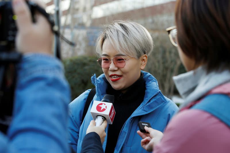 Teresa Xu talks to journalists outside Chaoyang People's Court before a court hearing of her suit against a Beijing hospital for rejecting her request to freeze her eggs on the grounds that she is unmarried, in Beijing