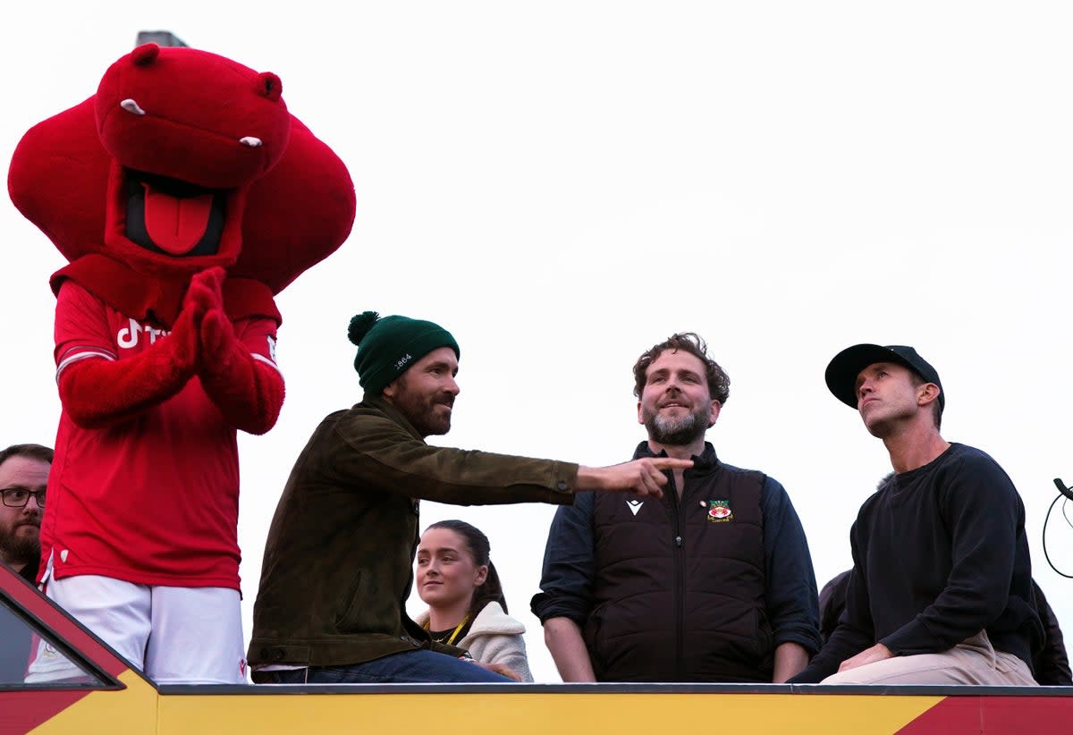 Ker with Wrexham owners Ryan Reynolds and Rob McElhenney (PA)