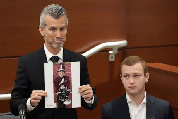 PHOTO: Max Schachter, with his son, Ryan holds a photograph of his other son, Alex, just before giving his victim impact statement during the penalty phase in the trial of MSD shooter Nikolas Cruz on Aug. 3, 2022 in Fort Lauderdale, Fla. (Amy Beth Bennett-Pool/Getty Images, FILE)