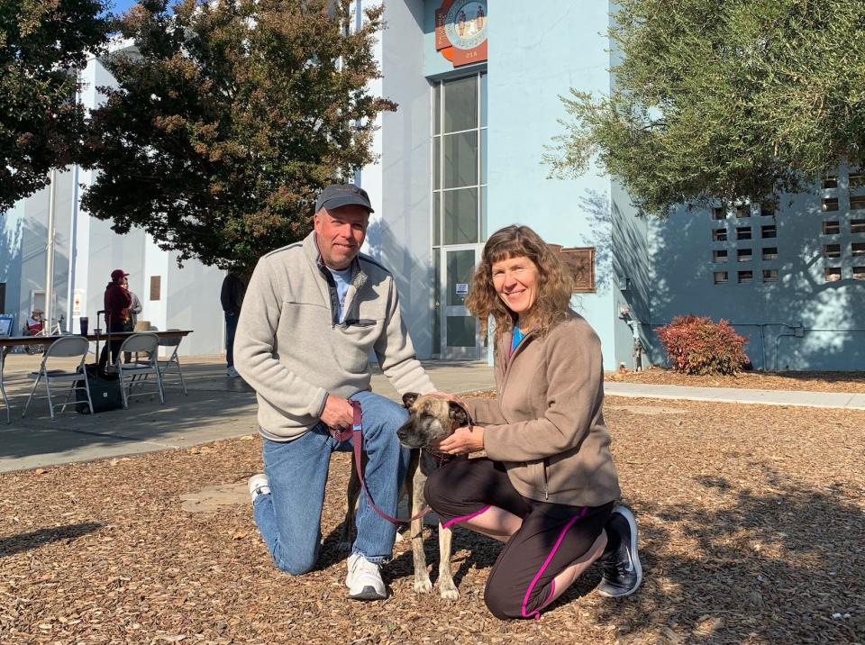 Gail (left) and Allison Baker, with their dog Muffin. The family, which includes the couple's teen daughter, were evacuated from their home near Santa Rosa due to the Kincade Fire, and are finding food and shelter at a Red Cross administered shelter in town.