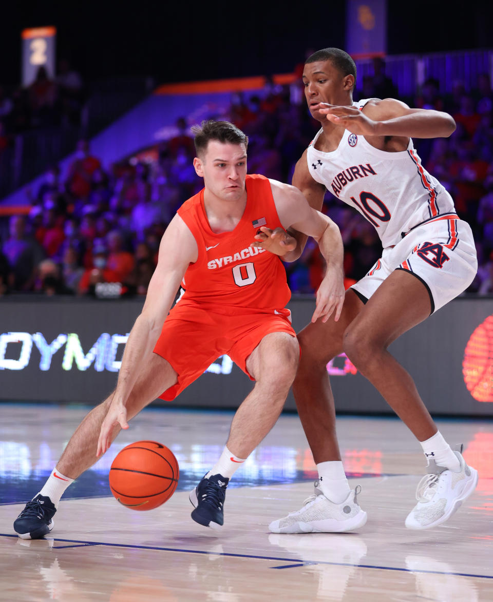 In this photo provided by Bahamas Visual Services, Syracuse forward Jimmy Boeheim (0) controls the ball against Auburn forward Jabari Smith during an NCAA college basketball game at Paradise Island, Bahamas, Friday, Nov. 26, 2021. (Tim Aylen/Bahamas Visual Services via AP)