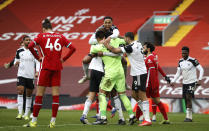 Fulham players celebrate at the end of the English Premier League soccer match between Liverpool and Fulham at Anfield stadium in Liverpool, England, Sunday, March 7, 2021. (Phil Noble/Pool via AP)