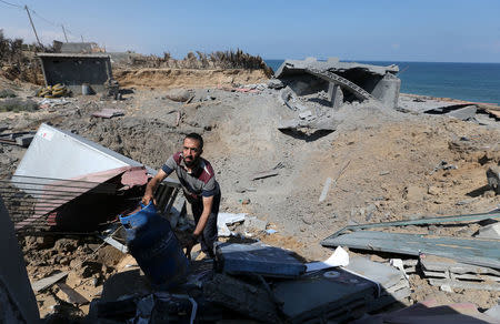 A Palestinian man inspects a destroyed Islamic Jihad military base after it was targeted by an Israeli warplane, at the southern Gaza Strip May 30, 2018. REUTERS/Ibraheem Abu Mustafa