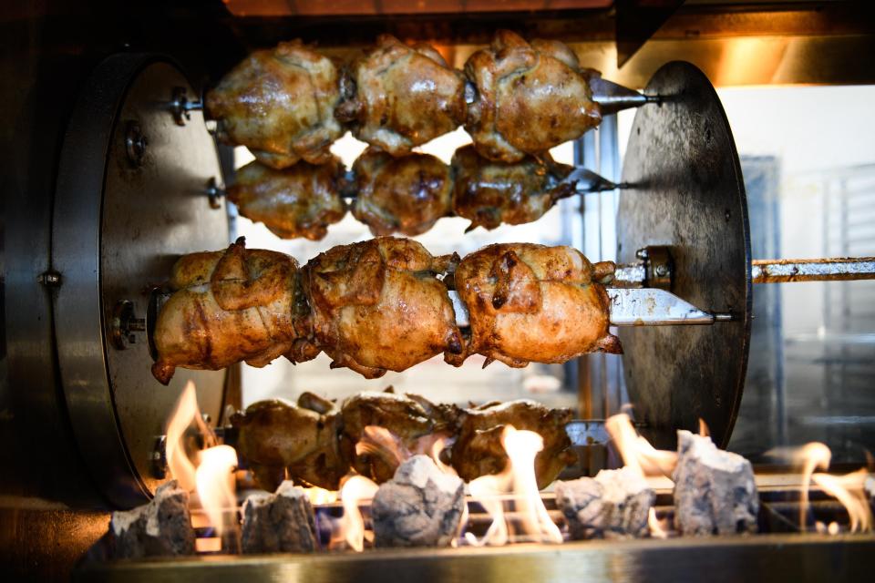 Rotisserie chicken cook over charcoal at Fabe's Charcoal Roasting Co. in the Freedom Town Center near the corner of Skibo and Cliffdale roads.