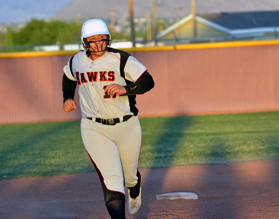 Centennial's Amanda Valles rounds second base after blasting a two run homer against the Cibola Cougars in first round action of the state softball playoffs.