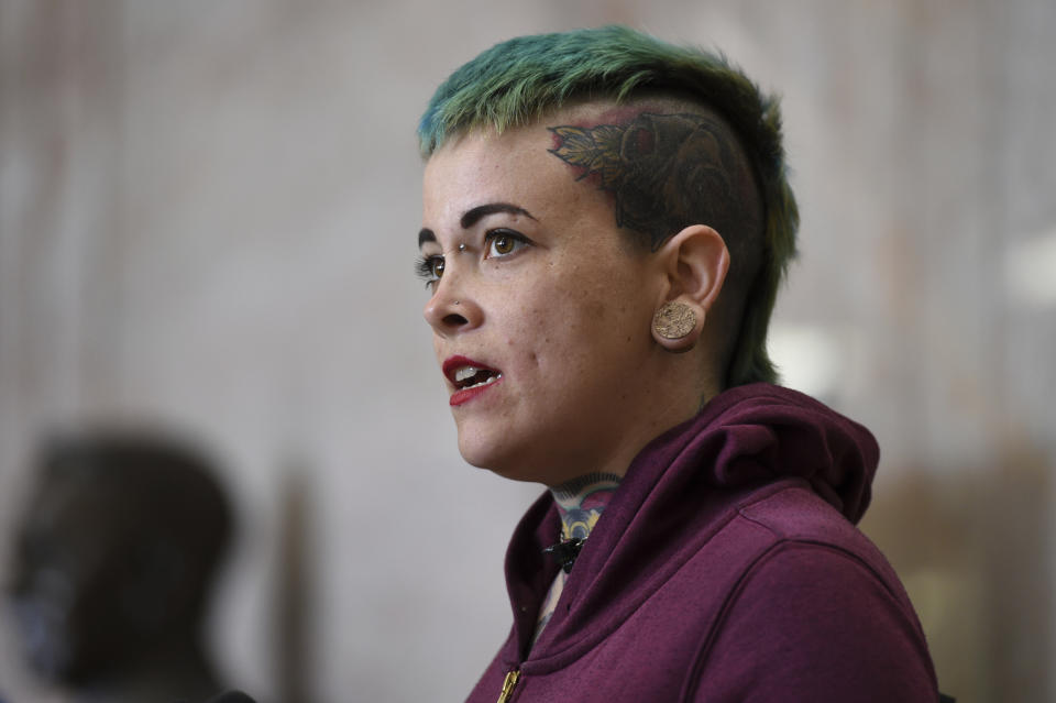 Danielle Silva, of Oakland, Calif., who identified herself as a Max Harris supporter, speaks to the media at the Alameda County Courthouse in Oakland, Calif., Tuesday April, 30, 2019. Two defendants, Derick Almena and Max Harris are standing trial on charges of involuntary manslaughter after a 2016 fire killed 36 people at a warehouse party they hosted in Oakland. (AP Photo/Cody Glenn)