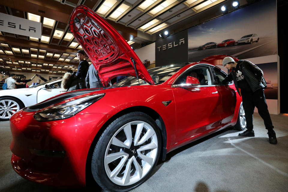 A visitor views the Tesla Model 3 electric vehicle at the Canadian International Auto Show in Toronto, Ontario, Canada February 18, 2020.   REUTERS/Chris Helgren