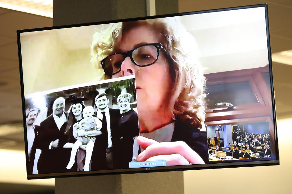 Gillian Millane holds a family photograph during her televised victim impact statement from her home in the UK (Getty Images)