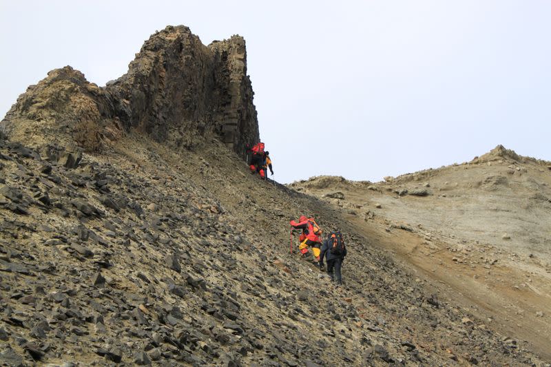 People hike during an expedition on Seymour Island in Antarctica