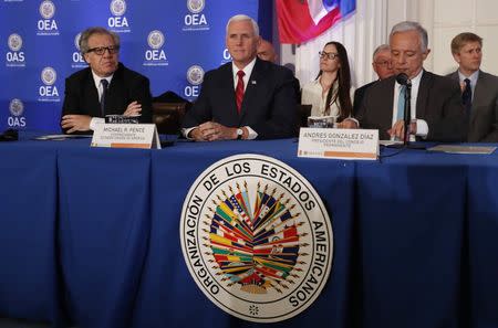 U.S. Vice President Mike Pence sits between OAS Secretary General Luis Almagro and OAS President Andres Gonzalez Diaz as he waits to address the Organization of American States (OAS) in Washington, U.S. May 7, 2018. REUTERS/Kevin Lamarque