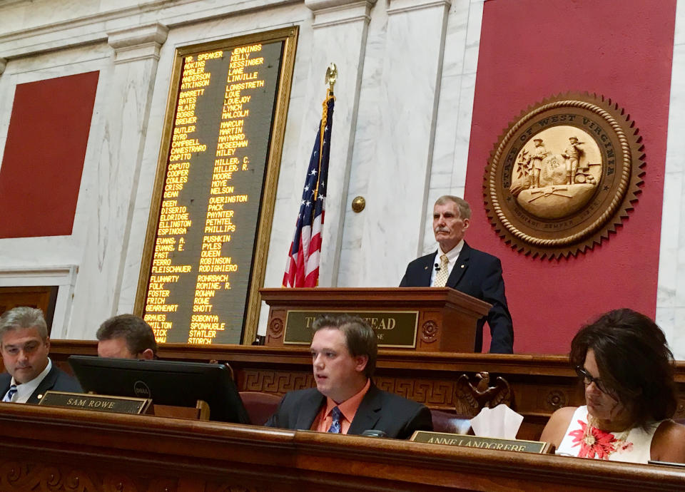 West Virginia House Speaker Pro Tempore John Overington, top, presides over the start of a hearing Monday, Aug. 13, 2018, at the state Capitol in Charleston, W. Va. The House of Delegates is considering the impeachment of the entire state Supreme Court in a scandal over $3.2 million in office renovations. (AP Photo/John Raby)