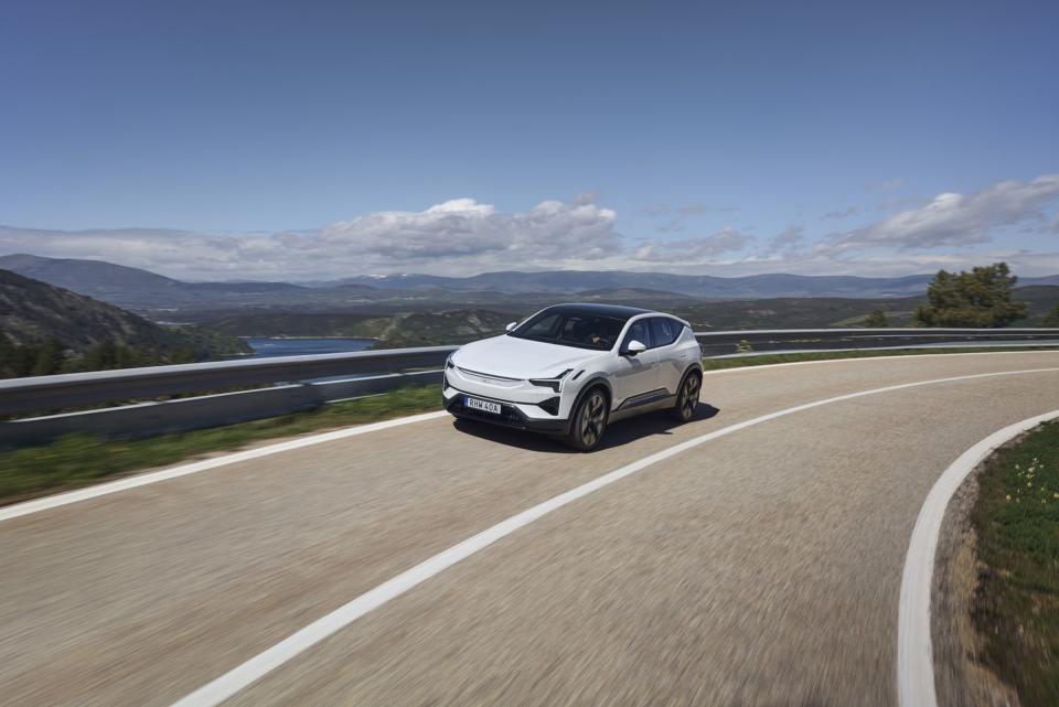 a white car driving on a road