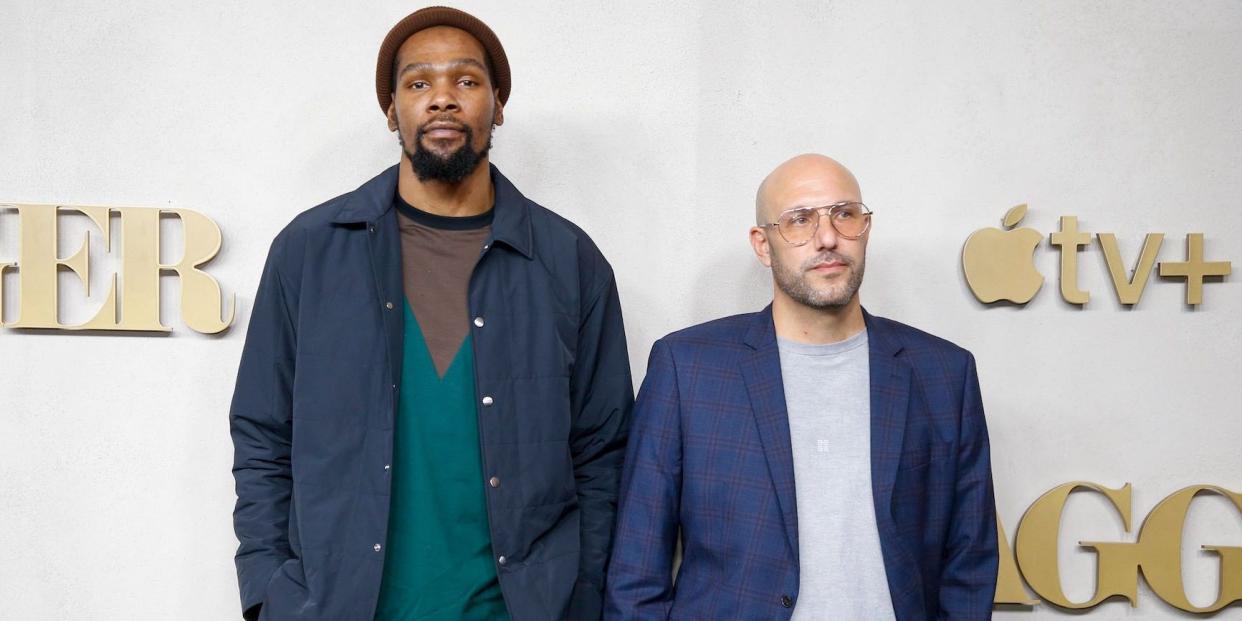 Kevin Durant and Rich Kleiman stand next to each other while posing at the premier of "Swagger."