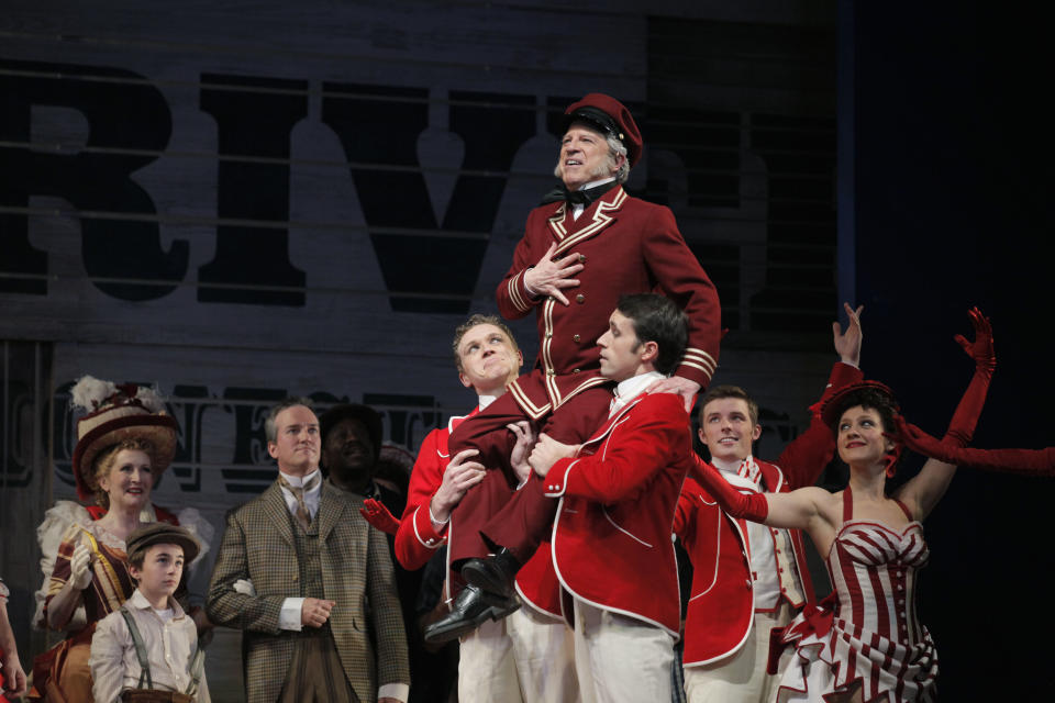 In this photo taken Feb. 9, 2012, Ross Lehman, portraying Captain Andy Hawks, rests on the shoulders of fellow performers at a dress rehearsal during the first act of the Lyric Opera of Chicago's production of "Show Boat." (AP Photo/M. Spencer Green)