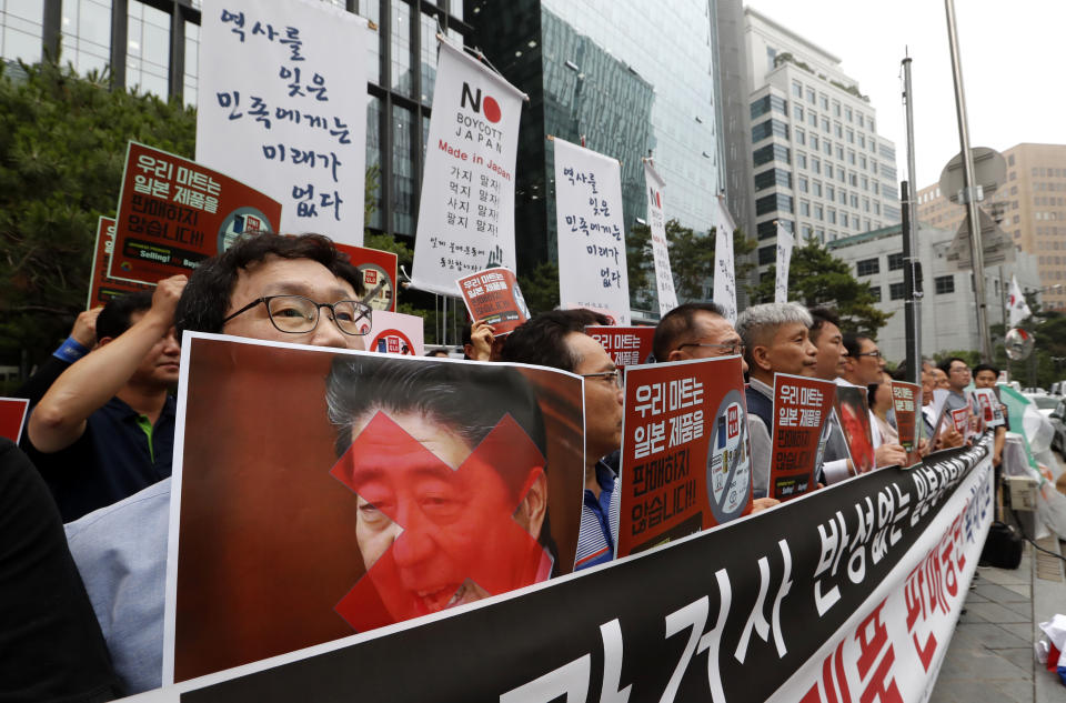 South Korean small and medium-sized business owners stage a rally calling for a boycott of Japanese products in front of the Japanese embassy in Seoul, South Korea, Monday, July 15, 2019. South Korea and Japan last Friday, July 12, failed to immediately resolve their dispute over Japanese export restrictions that could hurt South Korean technology companies, as Seoul called for an investigation by the United Nations or another international body. The signs read: "We don't sell Japanese products." (AP Photo/Ahn Young-joon)