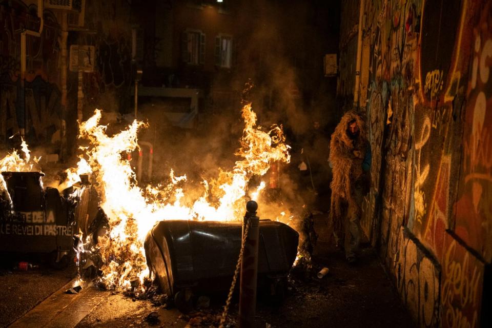 Rubbish bins set alight during riots in Marseille, southern France, on Sunday (AP)