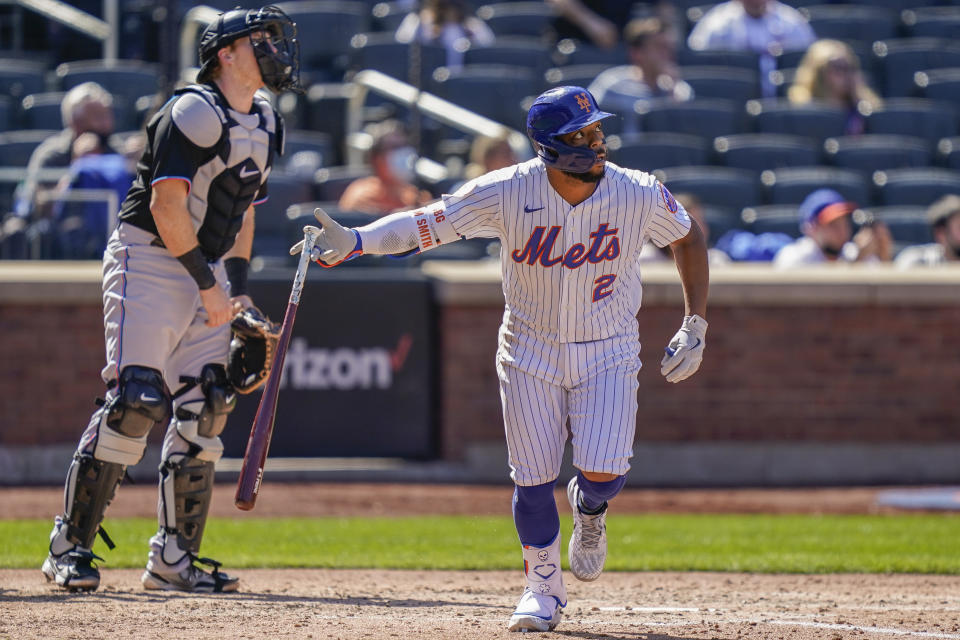 New York Mets' Dominic Smith hits an RBI sacrifice fly off Miami Marlins relief pitcher Ross Detwiler during the fifth inning of a baseball game, Thursday, April 8, 2021, in New York. (AP Photo/John Minchillo)