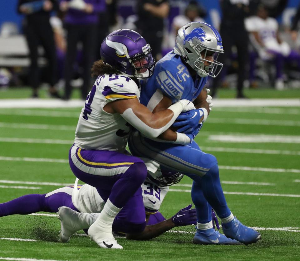 Lions running back Justin Jackson is tackled by Vikings linebacker Eric Kendricks during the second half of the Lions' 34-23 win over the Vikings on Sunday, Dec. 11, 2022, at Ford Field.