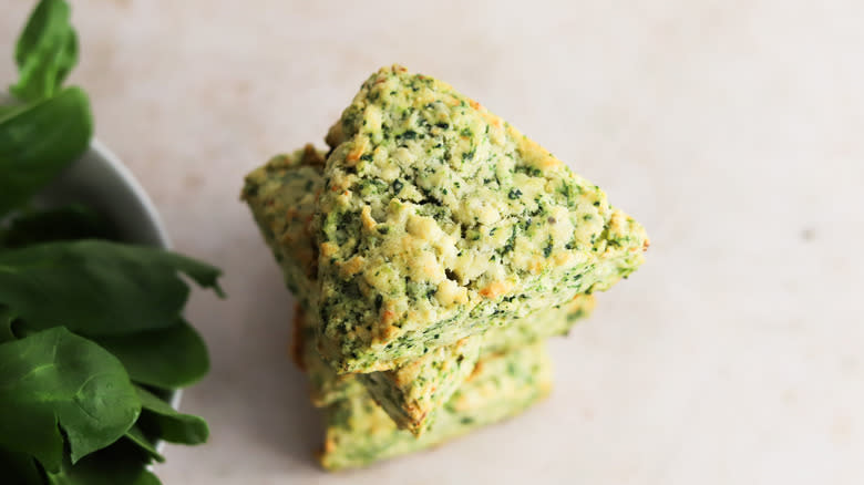 spinach and feta scones stacked on counter
