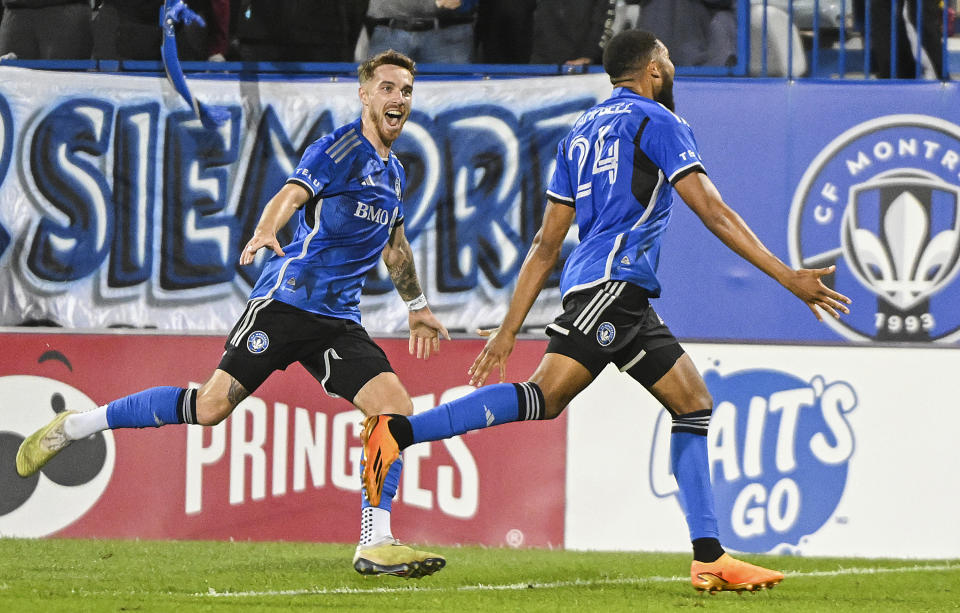 CF Montreal's George Campbell, right, celebrates with Joel Waterman after scoring against the New England Revolution during the second half of an MLS soccer match Saturday, Aug. 26, 2023, in Montreal. (Graham Hughes/The Canadian Press via AP)