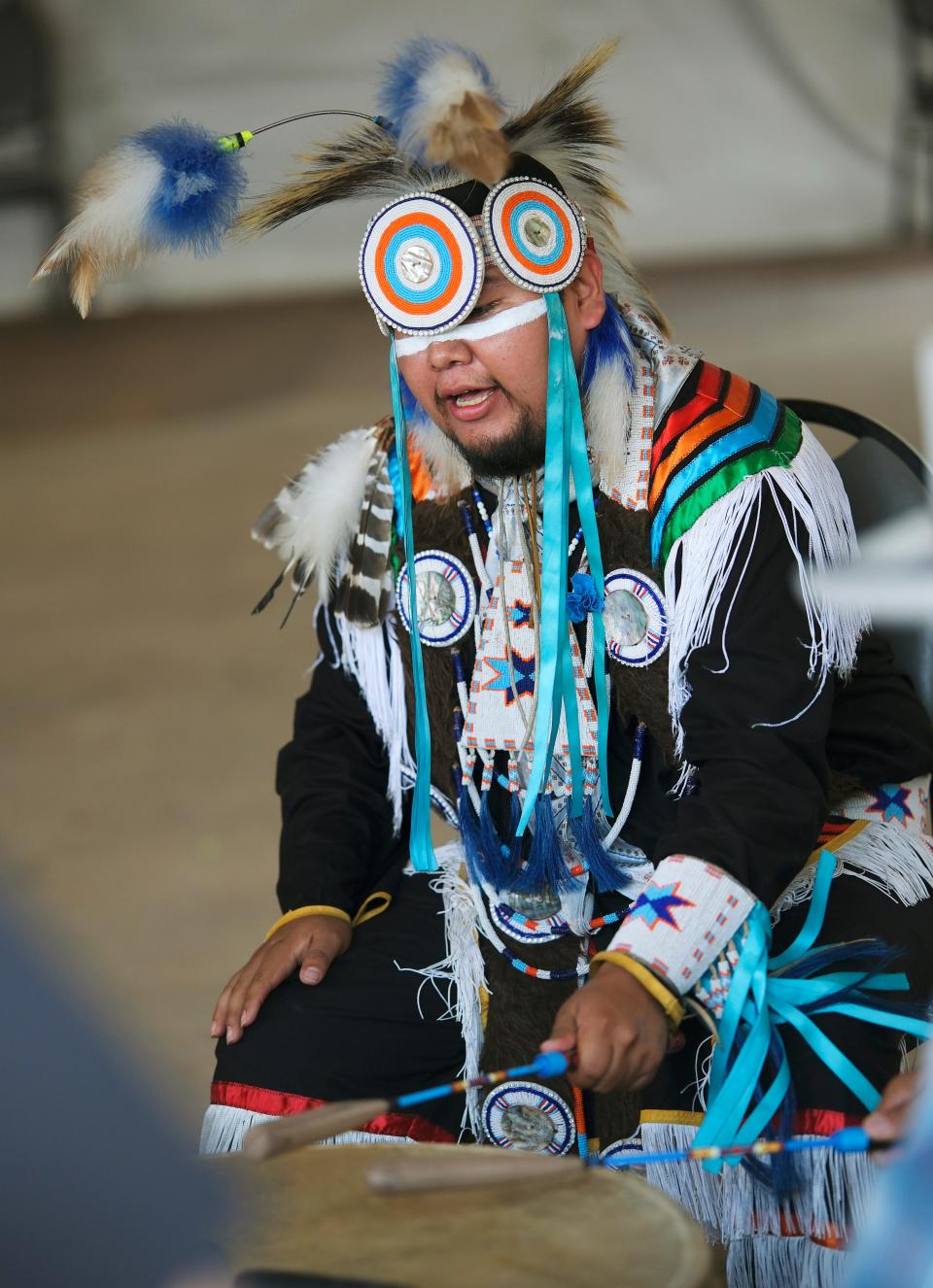 Bryson Sanchez, Pakota, sings and drums during a dance showcase by the Central Plains Dance Troupe at the Red Earth Festival at the National Cowboy and Western Heritage Museum Saturday, June 2 2023.