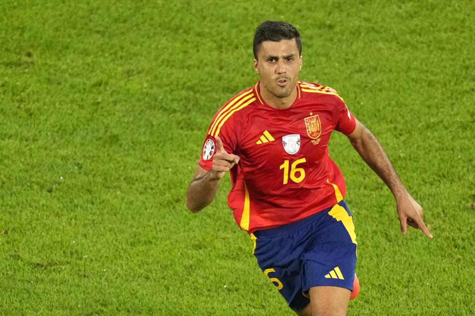 Spain's Rodri celebrates after scoring his side's opening goal during a round of sixteen match against Georgia at the Euro 2024 soccer tournament in Cologne, Germany, Sunday, June 30, 2024. (AP Photo/Andreea Alexandru)