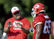 FILE - Then-Kansas City Chiefs assistant offensive line coach Eugene Chung, left, talks with lineman Tavon Rooks (65) during NFL football training camp practice n St. Joseph, Mo., in this Sunday, Aug. 2, 2015, file photo. Former NFL player and coach Eugene Chung is still waiting to meet with Commissioner Roger Goodell regarding an anti-Asian comment he says a team made about him during a job interview this year. Chung said on a conference call Monday, July 26, 2021, that he never was told by the league why a requested meeting with Goodell was not arranged nor how the NFL's investigation was conducted. (Andrew Carpenean/The St. Joseph News-Press via AP, File)