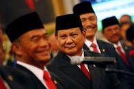 Head of Gerindra Party Prabowo Subianto, who was the former rival of Indonesian President Joko Widodo in April's election, looks on before taking his oath as appointed Defense Minister during the inauguration at the Presidential Palace in Jakarta