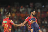 Punjab Kings' Arshdeep Singh, right, celebrates the wicket of Sunrisers Hyderabad's Shahbaz Ahmed during the Indian Premier League cricket match between Sunrisers Hyderabad and Punjab Kings in Hyderabad, India, Sunday, May19, 2024. (AP Photo/Mahesh Kumar A.)