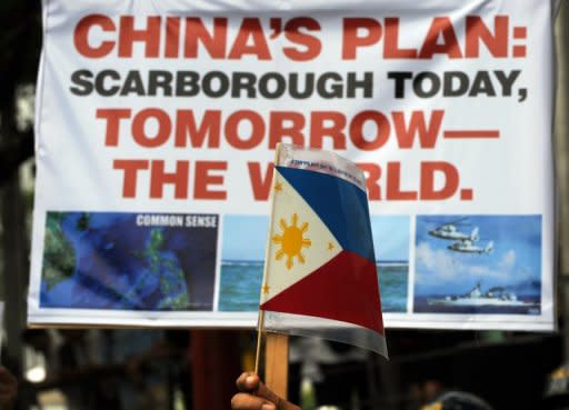 Anti-China protesters are pictured during a rally in front of the Chinese embassy in the financial district of Manila, on May 11. Hundreds of Filipinos came to demonstrated over an escalating territorial row, with the protesters denouncing China's rulers as arrogant bullies