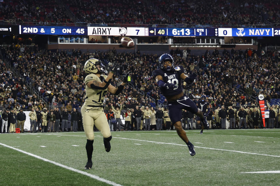 Navy safety Rayuan Lane III deflects a pass intended for Army wide receiver Noah Short during the second quarter of an NCAA football game at Gillette Stadium Saturday, Dec. 9, 2023, in Foxborough, Mass. (AP Photo/Winslow Townson)