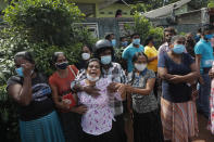 A family member of an inmate cries demanding the authorities reveal the condition of her relative as others console her outside the Mahara prison complex following an overnight unrest in Mahara, outskirts of Colombo, Sri Lanka, Monday, Nov. 30, 2020. Sri Lankan officials say six inmates were killed and 35 others were injured when guards opened fire to control a riot at a prison on the outskirts of the capital. Two guards were critically injured. Pandemic-related unrest has been growing in Sri Lanka's overcrowded prisons. (AP Photo/Eranga Jayawardena)