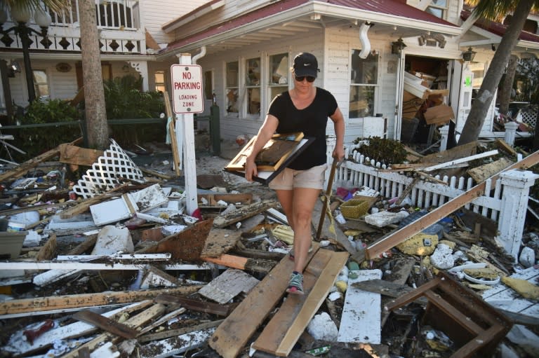 Brandy Jessen helps recovering belongings from her mother's house damaged by Hurricane Michael, in Mexico Beach, Florida, on October 13, 2018, three days after Hurricane Michael hit the area