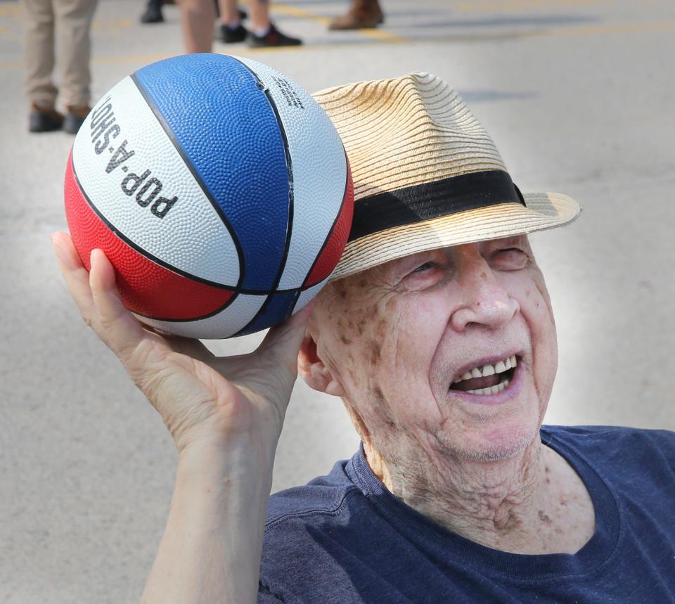 Richard Muse sinks some baskets at one of the game stations at Riverside Rest Home's Carnival July 19, 2023.