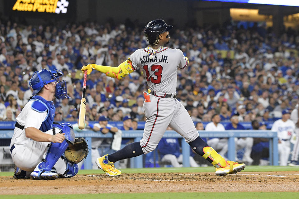 Atlanta Braves' Ronald Acuna Jr., right, hits a grand slam as Los Angeles Dodgers catcher Will Smith watches during the second inning of a baseball game Thursday, Aug. 31, 2023, in Los Angeles. (AP Photo/Mark J. Terrill)