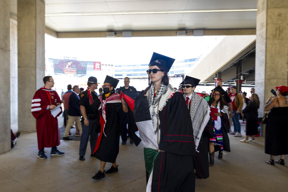 Pro-Palestinian demonstrators are escorted out of the UW-Madison Commencement ceremony at Camp Randall Stadium Madison, Wis., Saturday, May 11, 2024. The students protested during Chancellor Jennifer Mnookin's speech. (Samantha Madar/Wisconsin State Journal via AP)