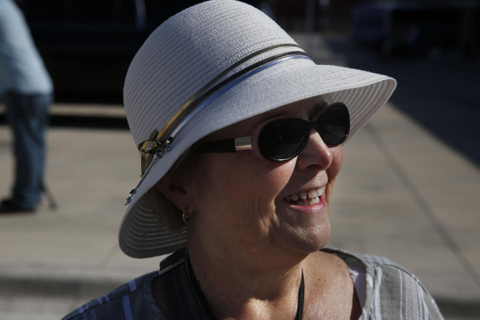 Marsha Booth, of W.Va., talks to the Associated Press as she leaves a cruise from Cuba out of Port Everglades on Wednesday, June 5, 2019, in Fort Lauderdale, Fla. The Trump administration on Tuesday imposed major new travel restrictions on visits to Cuba by U.S. citizens, including a ban on many forms of educational and recreational travel. (AP Photo/Brynn Anderson)