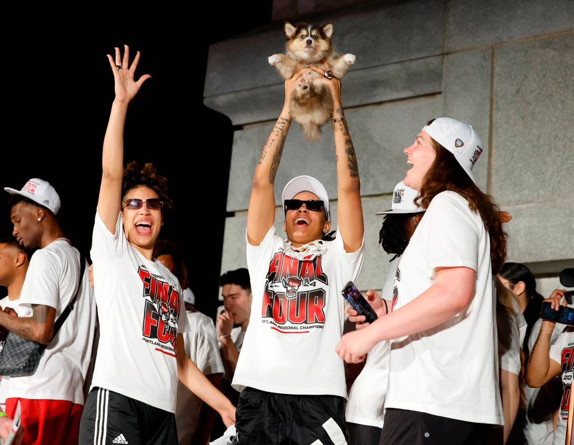 N.C. State’s Aziaha James, center, along with River Baldwin, right, and Madison Hayes celebrate after a ceremony for the N.C. State men’s and women’s basketball team at the Memorial Belltower in Raleigh, N.C., Monday, April 15, 2024. Both teams made it to the NCAA Tournament Final Four, the first time both teams made it in the same year.