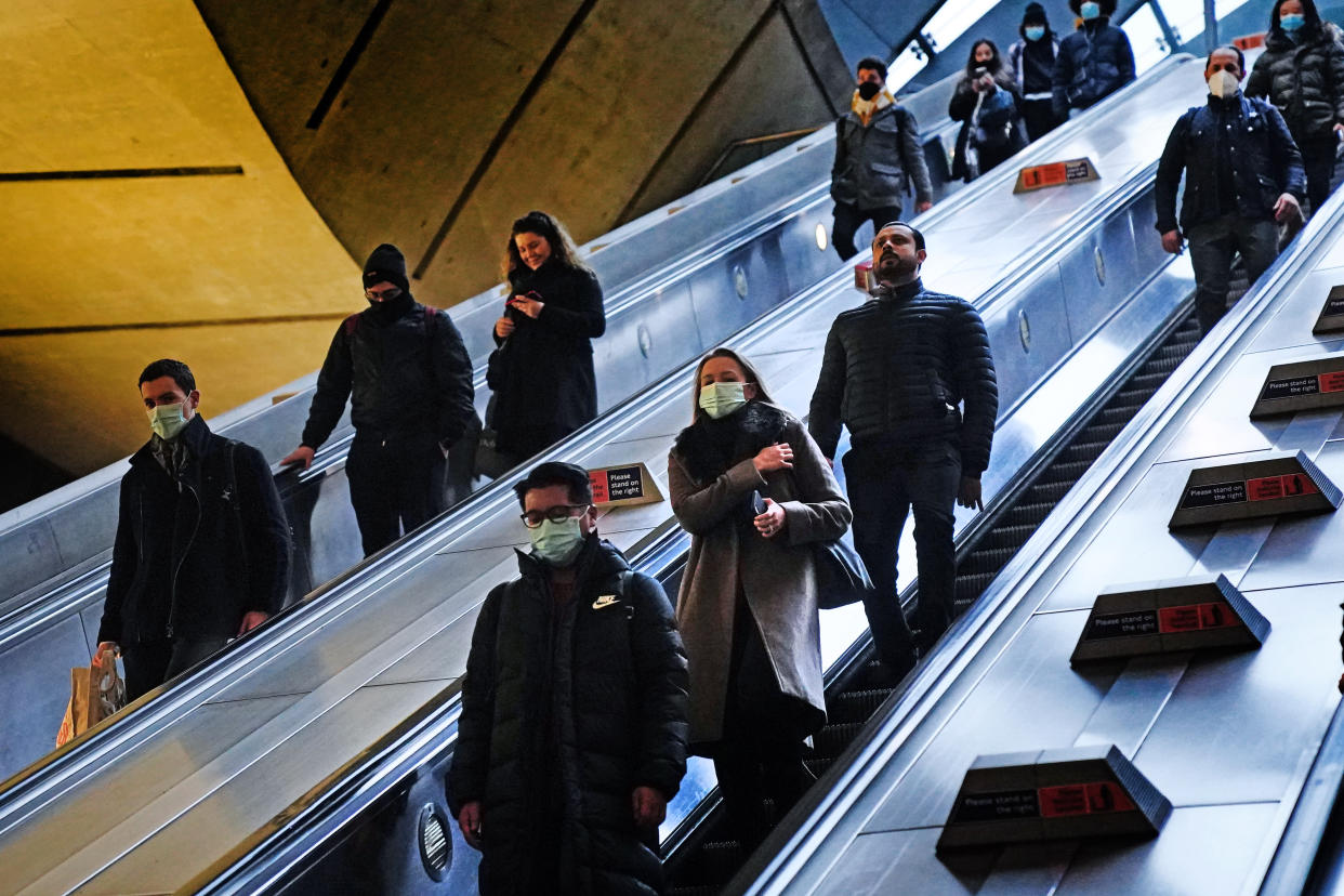 Commuters in Canary Wharf underground tube station in east London wear face coverings as mask wearing on public transport becomes mandatory to contain the spread of the Omicron Covid-19 variant. Picture date: Tuesday November 30, 2021.