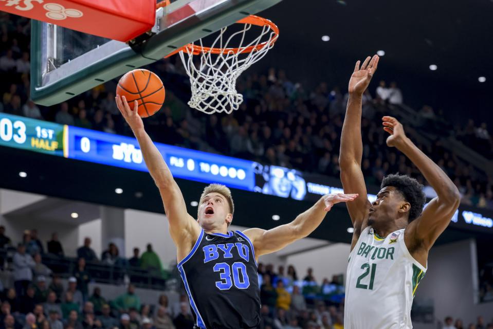 BYU guard Dallin Hall scores against Baylor center Yves Missi (21) Tuesday, Jan. 9, 2024, in Waco, Texas. Next up for the Cougars is an afternoon game Saturday at Central Florida. | Gareth Patterson, Associated Press