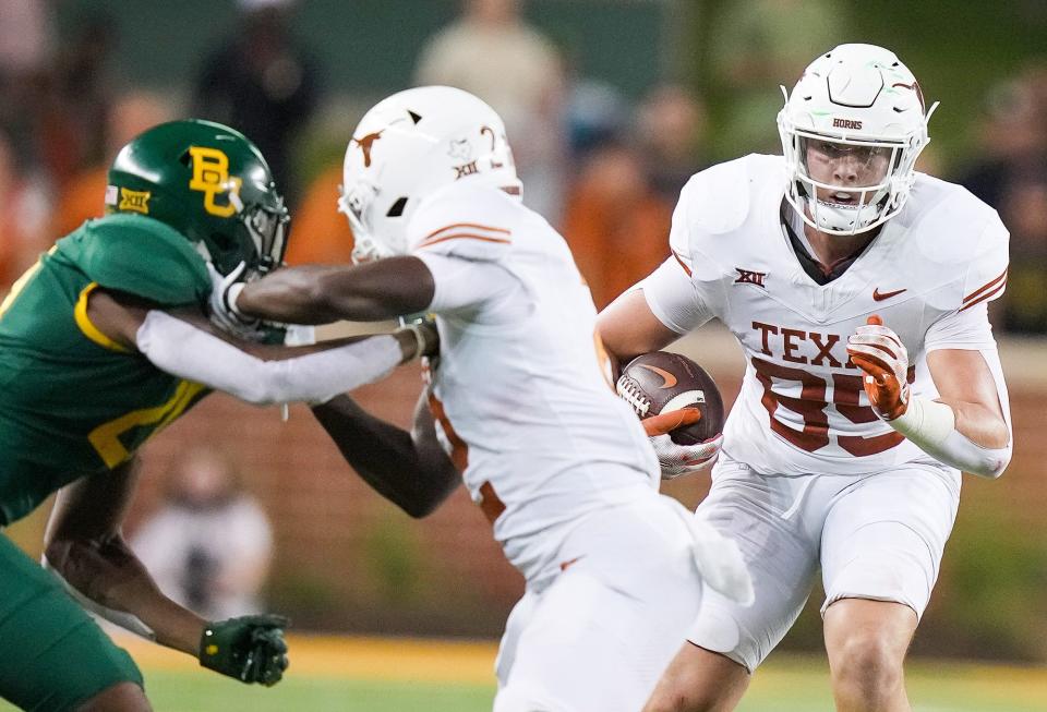 Texas tight end Gunnar Helm picks up a downfield block from wide receiver Johntay Cook II during a 38-6 win over Baylor last week. The success that UT wide receivers and tight ends are having as downfield blockers has made a tremendous difference this season, Texas coach Steve Sarkisian said.