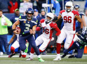 <p>Quarterback Russell Wilson #3 of the Seattle Seahawks rushes for 31 yards in the fourth quarter against the Arizona Cardinals, including Budda Baker #36 and Kareem Martin #96 at CenturyLink Field on December 31, 2017 in Seattle, Washington. (Photo by Jonathan Ferrey/Getty Images) </p>